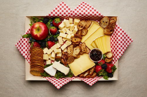 Cheese platter with crositini, jam, and fresh fruit
