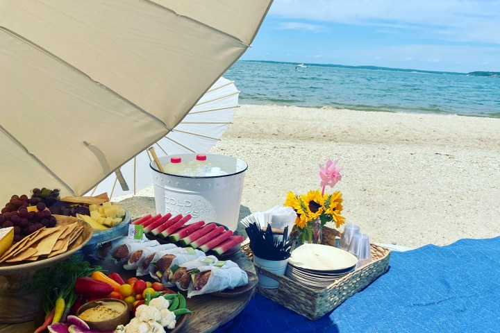 a person sitting at a table with a blue umbrella